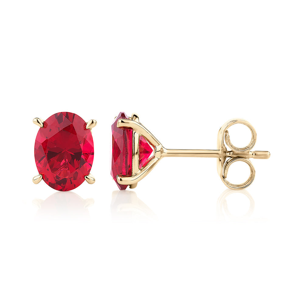 Oval stud earrings with ruby simulants in 10 carat yellow gold