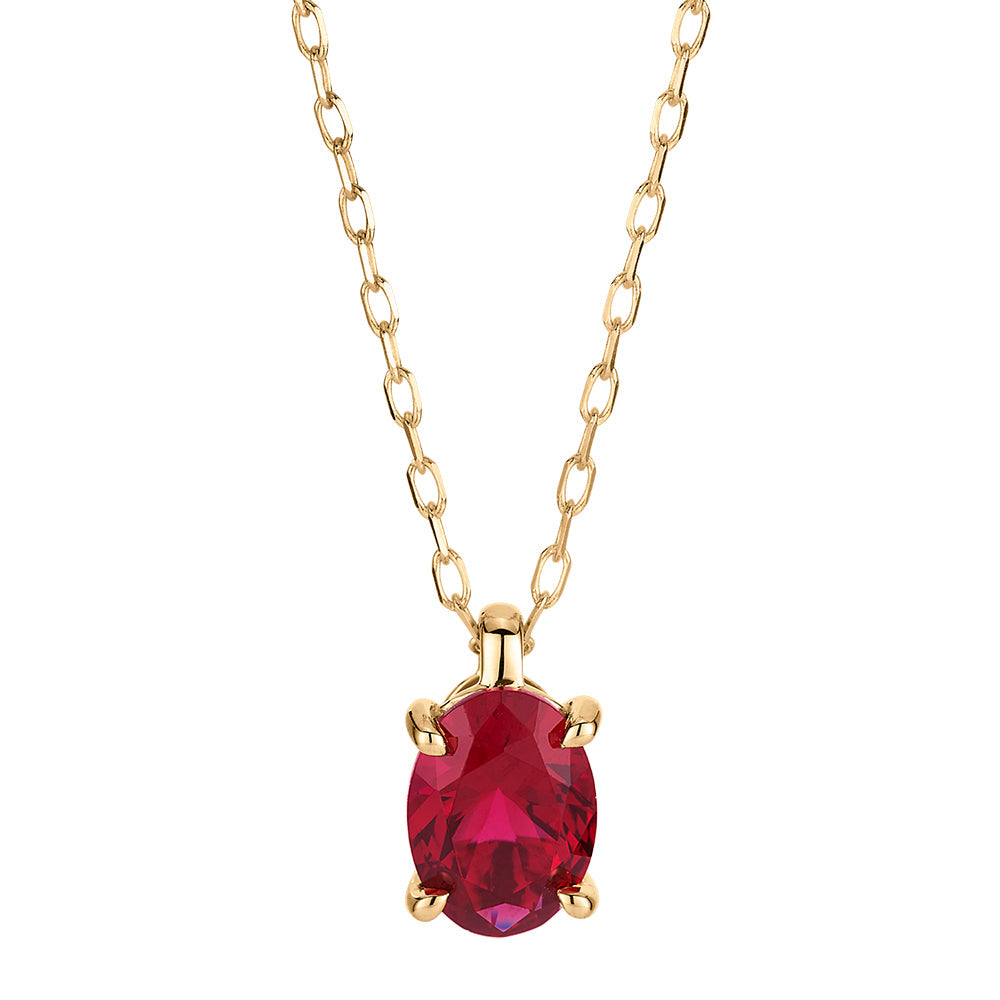 Oval solitaire necklace with ruby simulant in 10 carat yellow gold