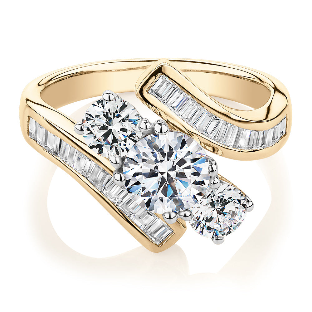 Three stone ring with 2.63 carats* of diamond simulants in 10 carat yellow and white gold