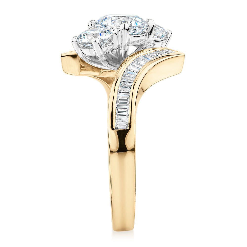 Three stone ring with 2.63 carats* of diamond simulants in 10 carat yellow and white gold