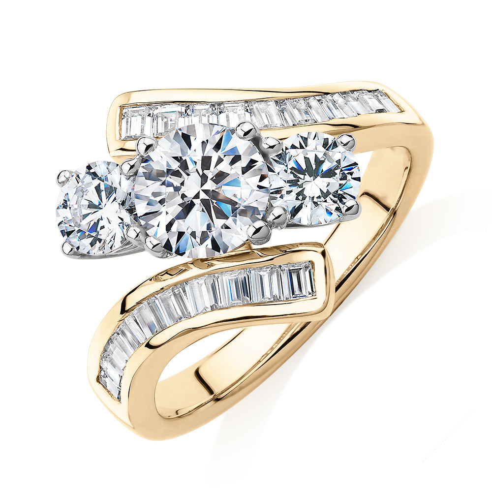 Three stone ring with 2.63 carats* of diamond simulants in 10 carat yellow and white gold