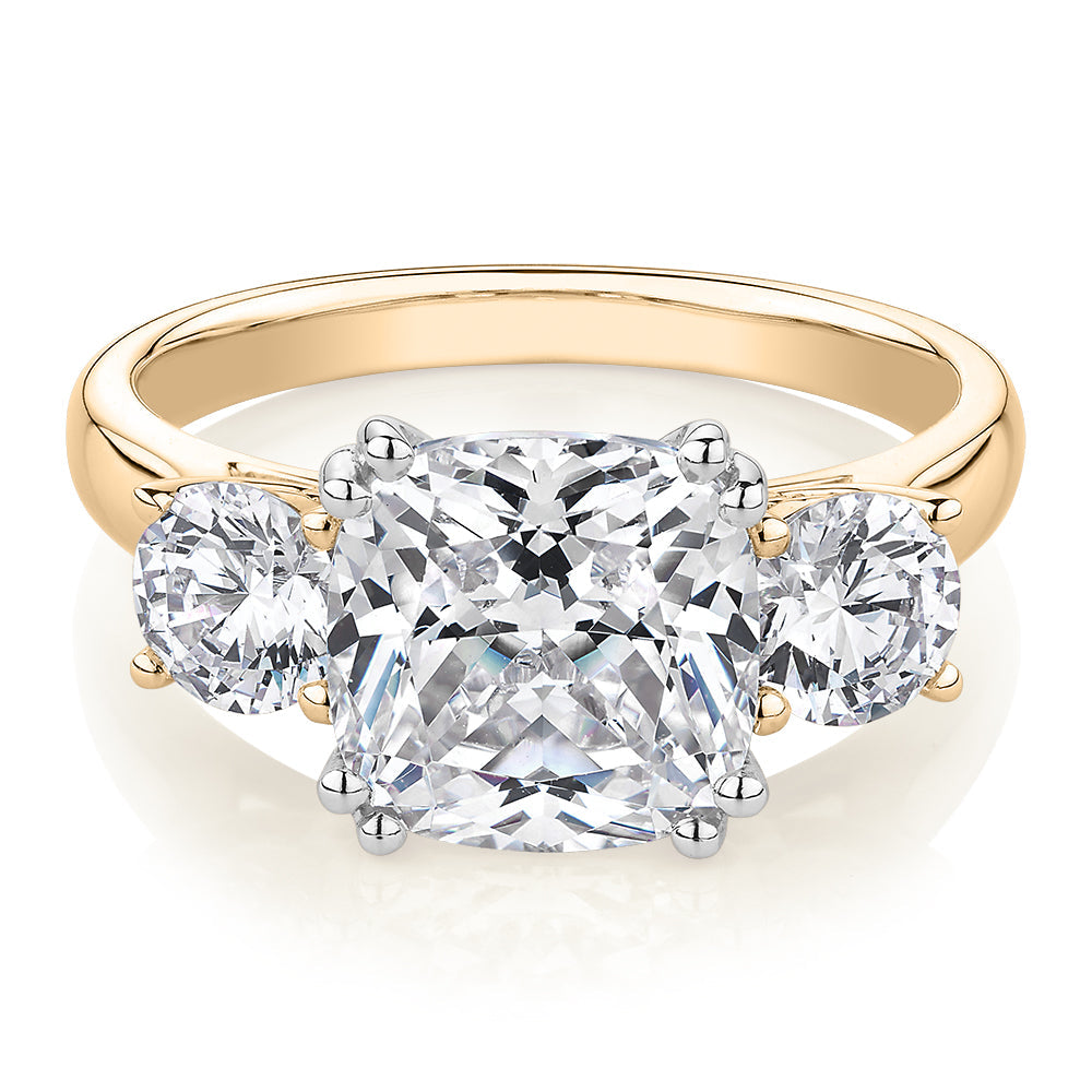 Three stone ring with 3.75 carats* of diamond simulants in 10 carat yellow and white gold