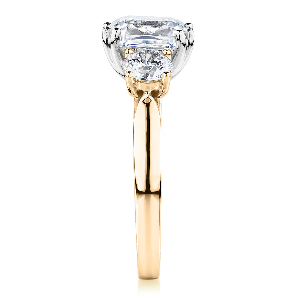 Three stone ring with 3.75 carats* of diamond simulants in 10 carat yellow and white gold