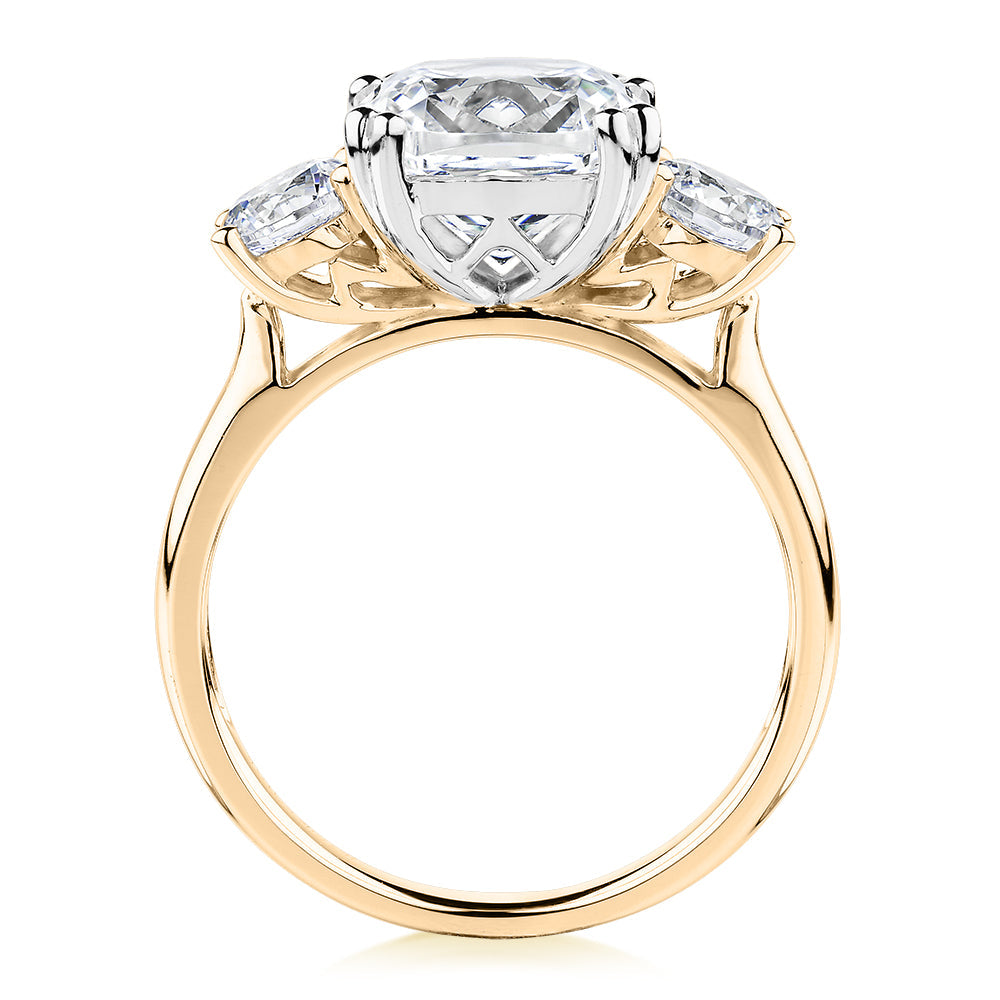 Three stone ring with 3.75 carats* of diamond simulants in 10 carat yellow and white gold