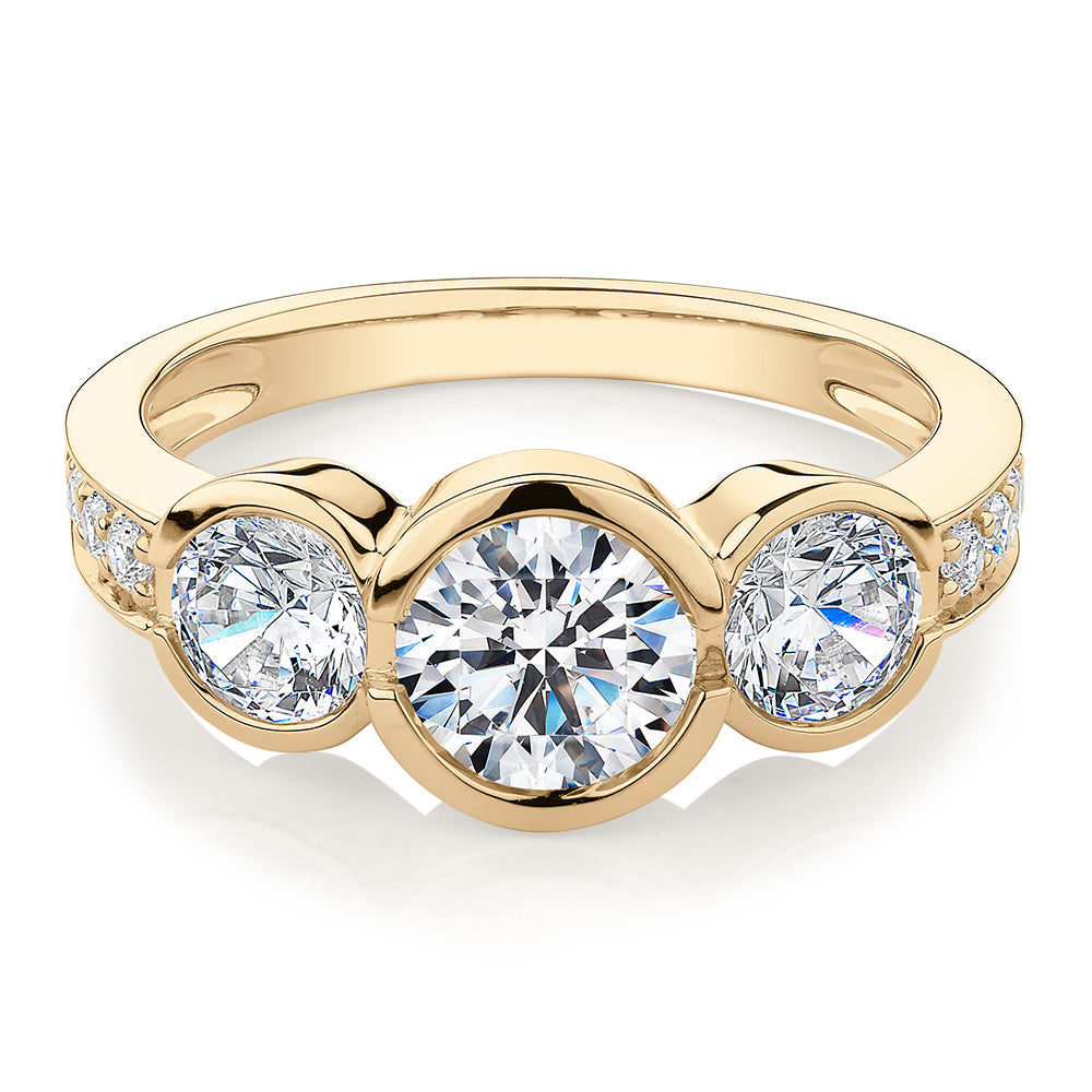 Three stone ring with 2.11 carats* of diamond simulants in 10 carat yellow gold