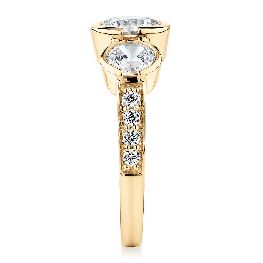 Three stone ring with 2.11 carats* of diamond simulants in 10 carat yellow gold