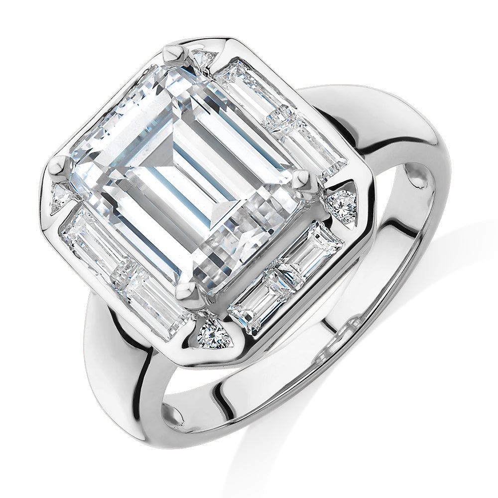 Emerald Cut, Baguette and Round Brilliant halo engagement ring with 4.53 carats* of diamond simulant