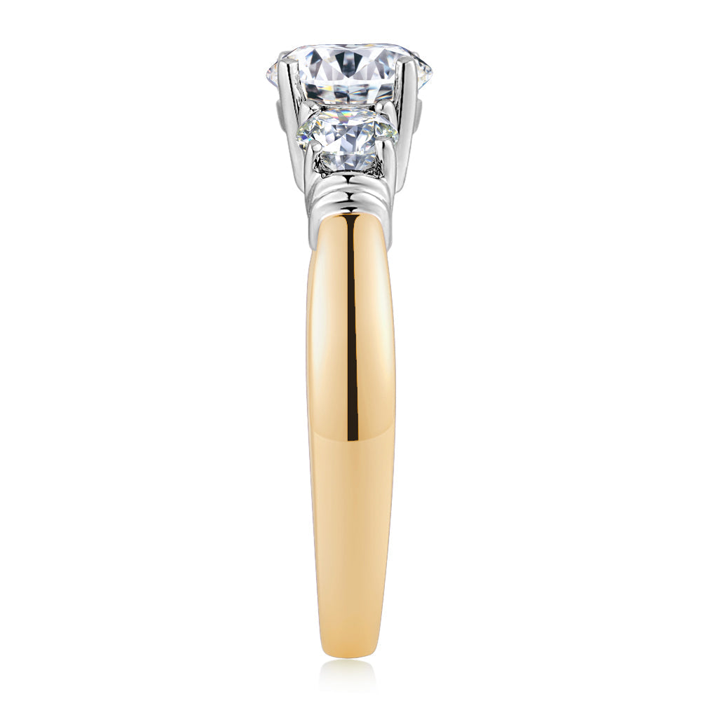 Three stone ring with 1.53 carats* of diamond simulants in 14 carat yellow and white gold