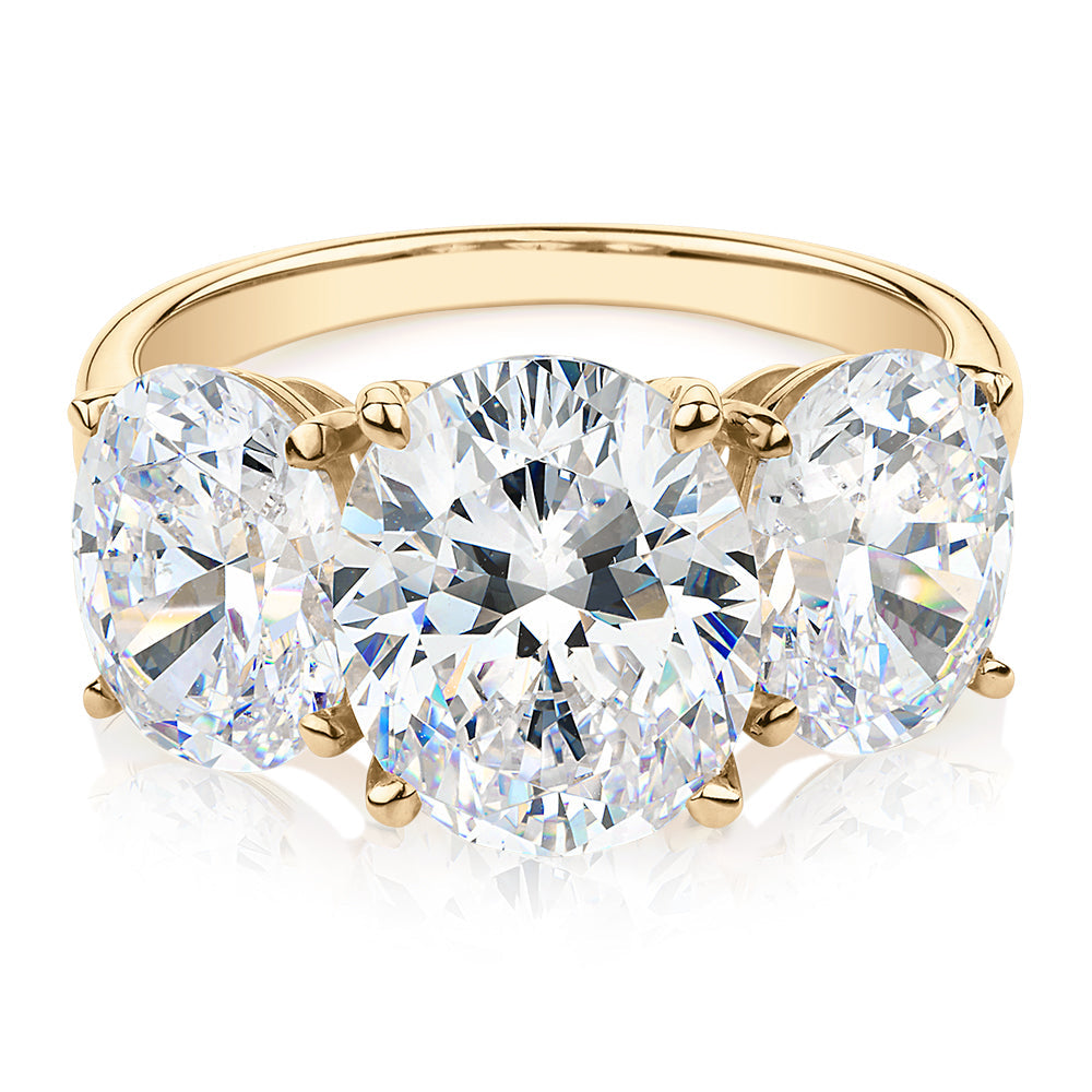 Three stone ring with 7.57 carats* of diamond simulants in 10 carat yellow gold