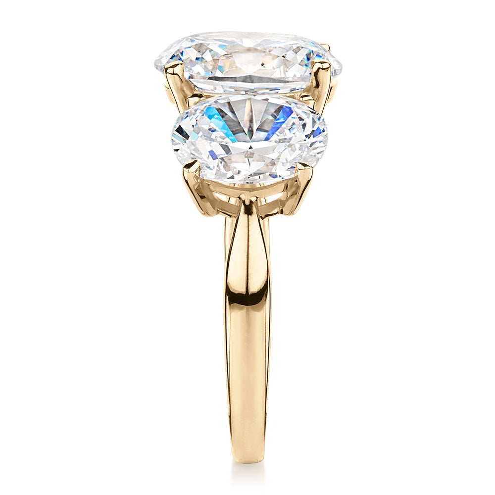 Three stone ring with 7.57 carats* of diamond simulants in 10 carat yellow gold