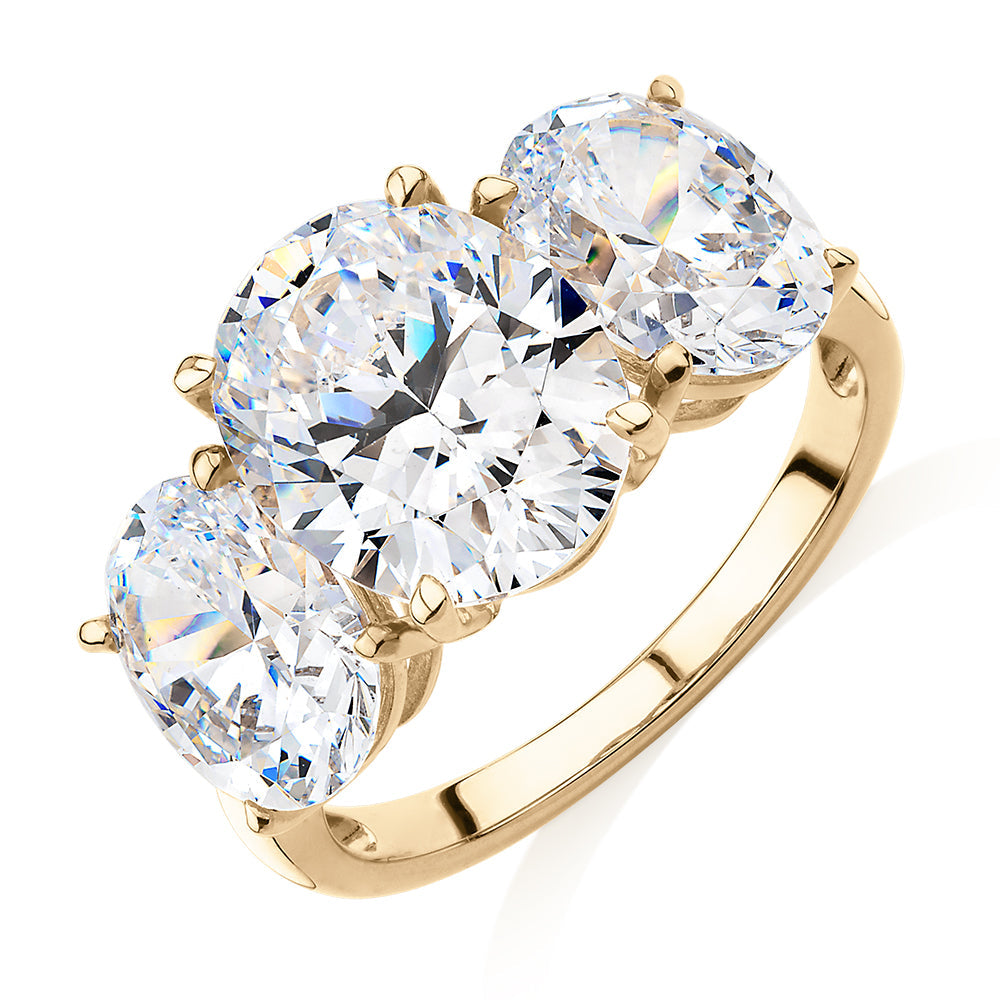 Three stone ring with 7.57 carats* of diamond simulants in 10 carat yellow gold