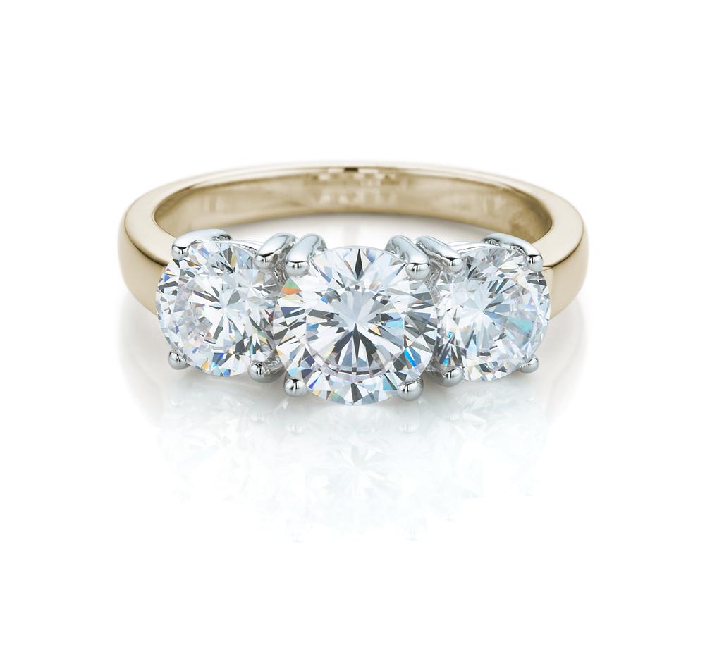 Three stone ring with 2 carats* of diamond simulants in 10 carat yellow and white gold