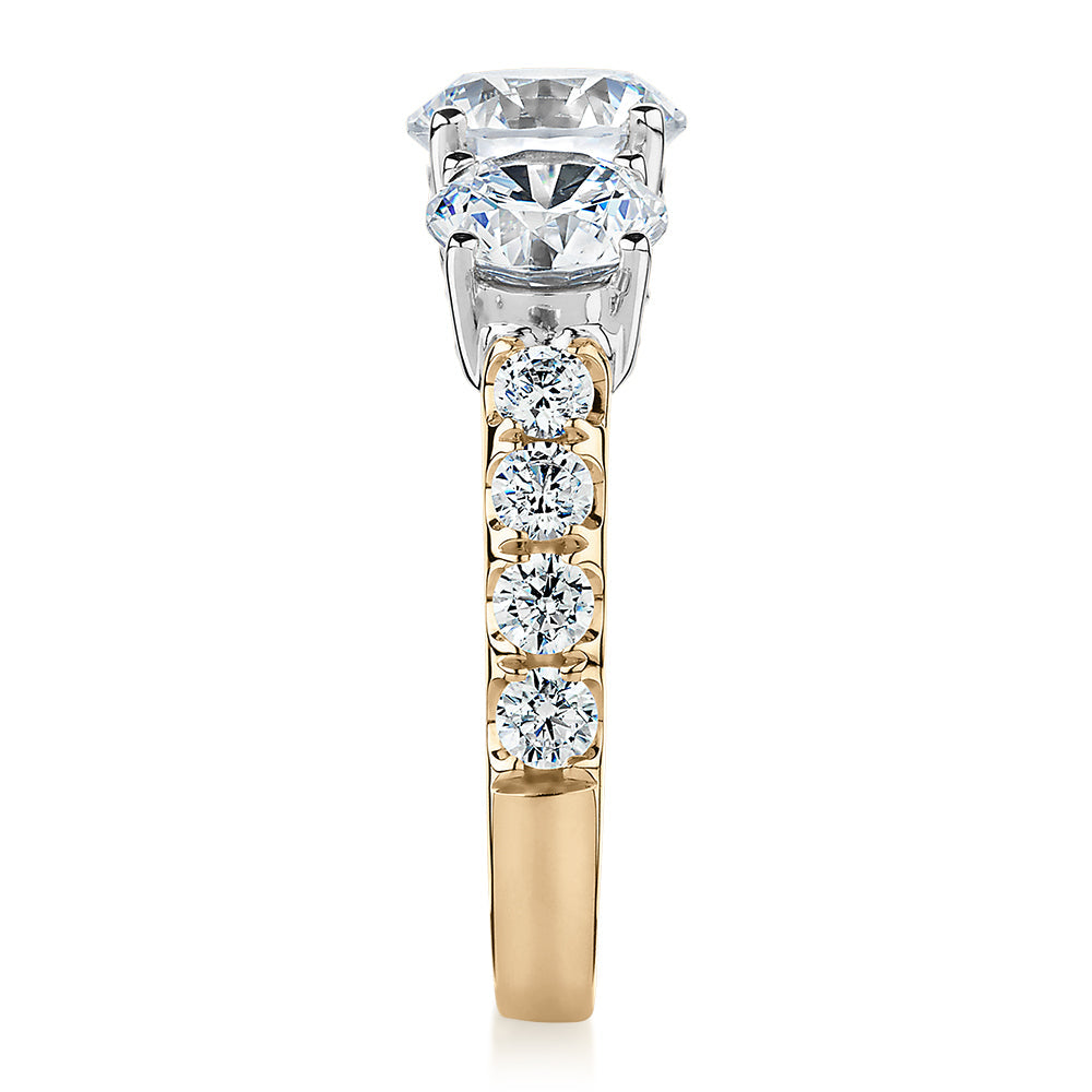 Three stone ring with 3.44 carats* of diamond simulants in 10 carat yellow and white gold