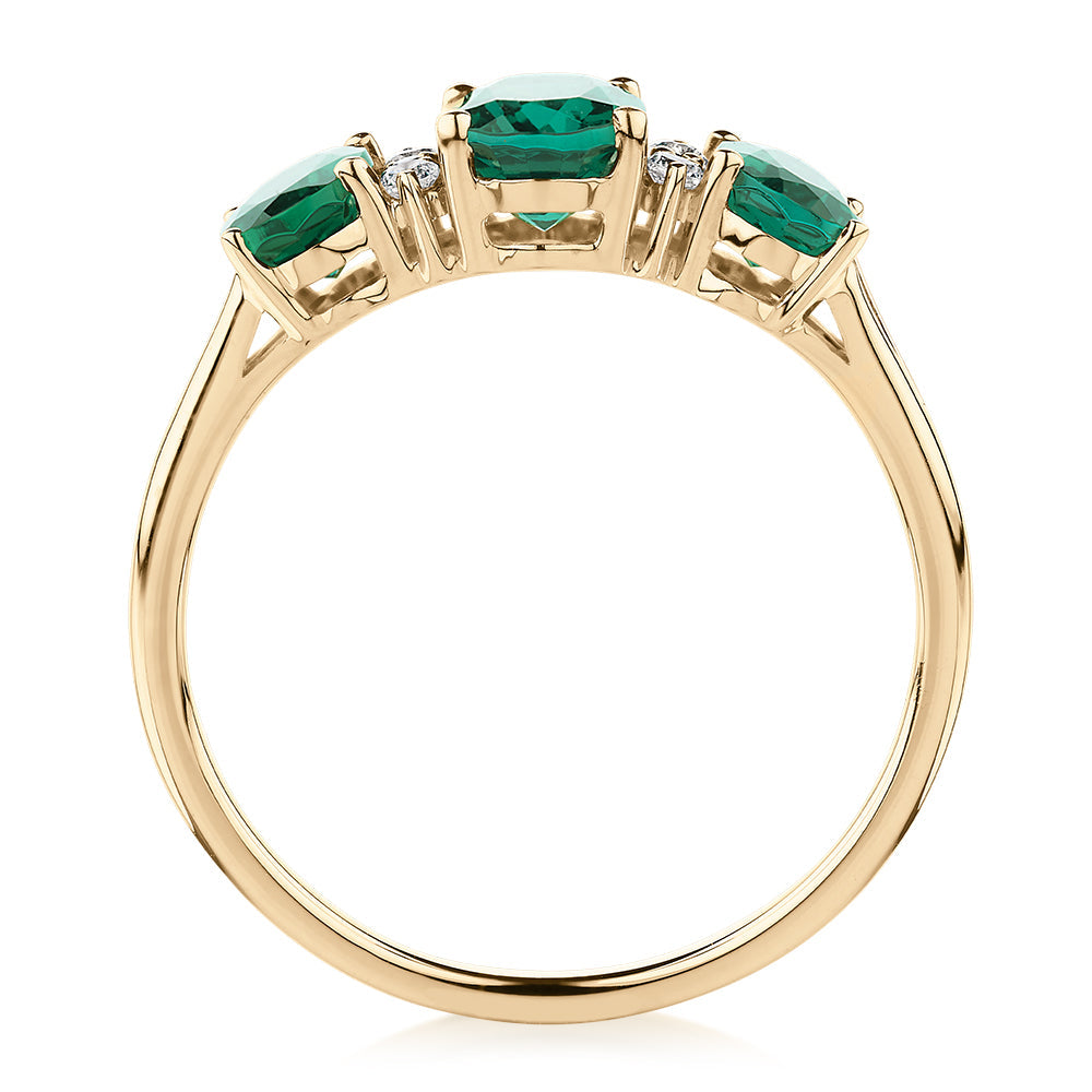 Dress ring with emerald and diamond simulants in 10 carat yellow gold