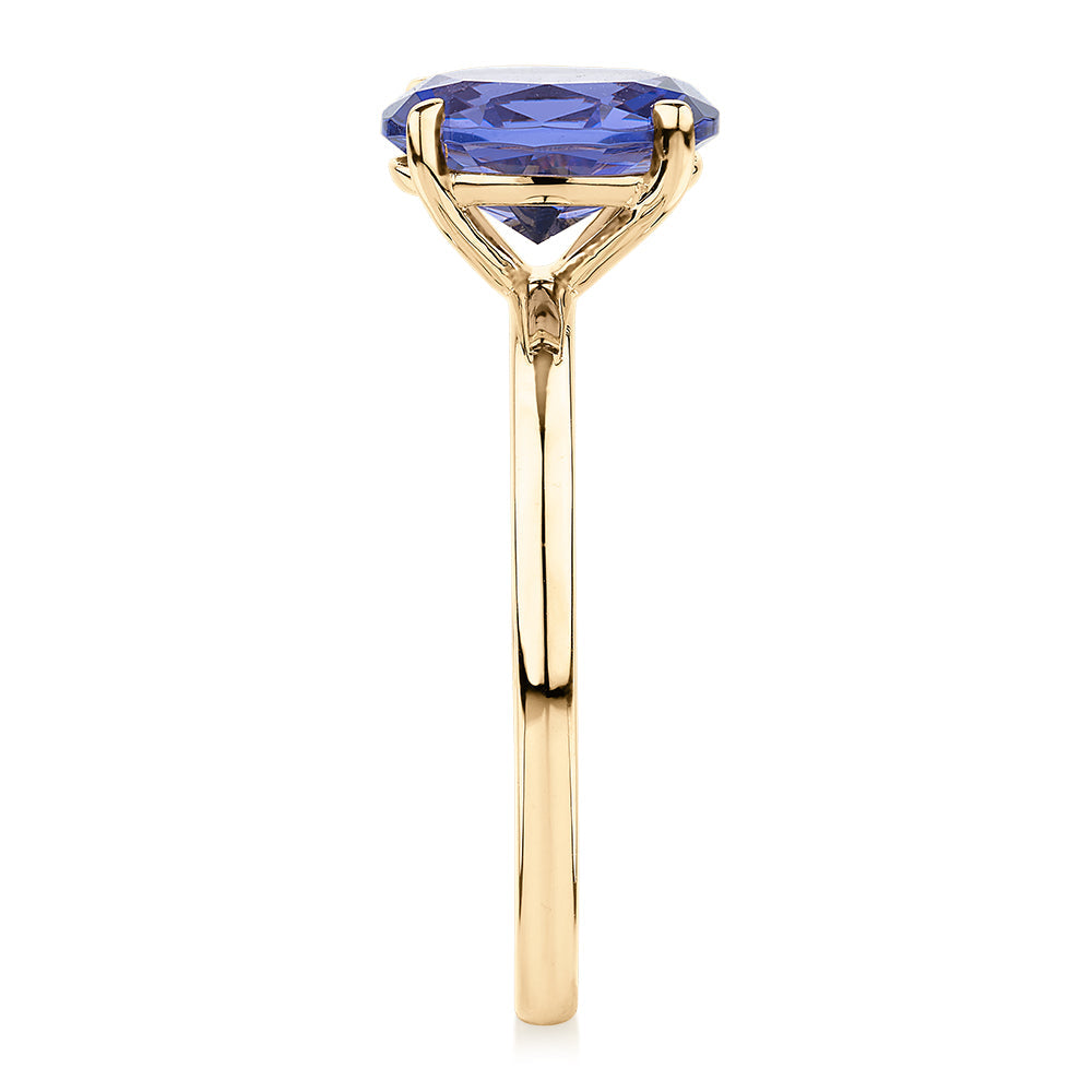 Dress ring with tanzanite simulant in 10 carat yellow gold