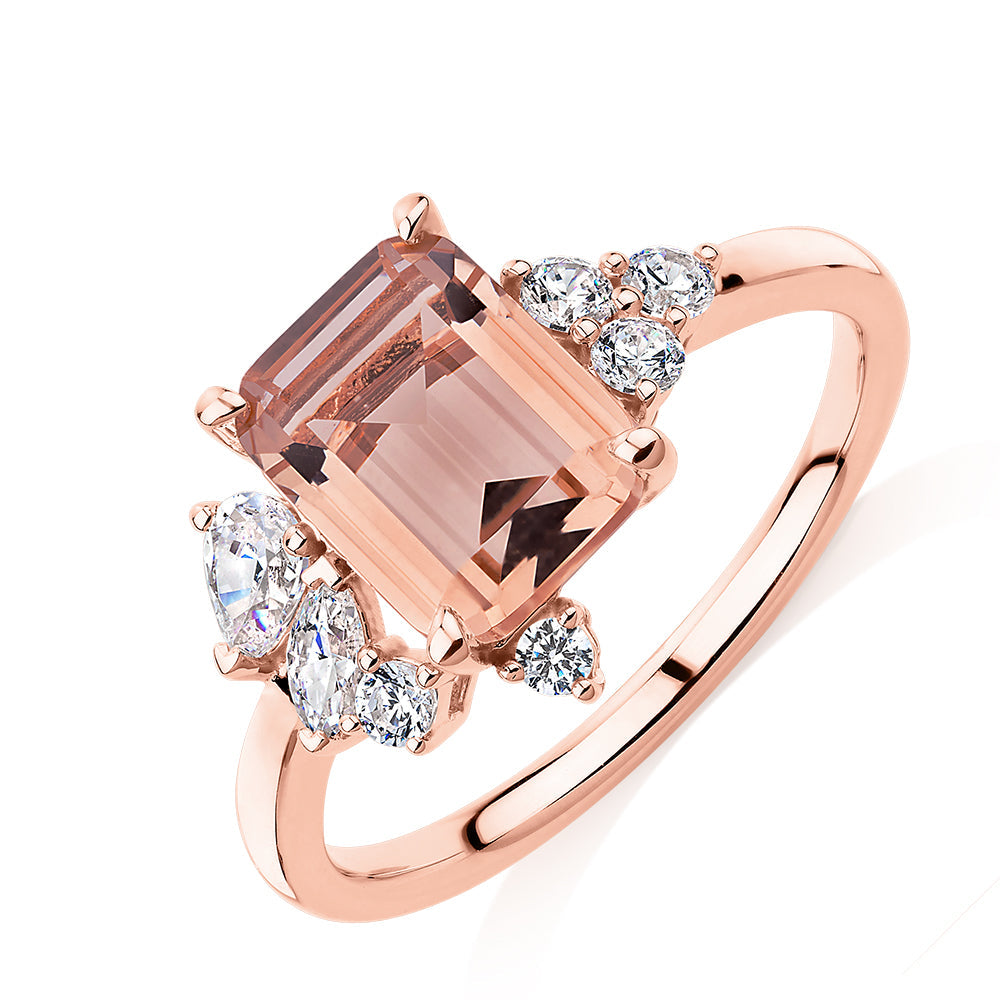 Emerald Cut and Round Brilliant shouldered engagement ring with morganite simulant and 0.45 carats* of diamond simulants in 10 carat rose gold