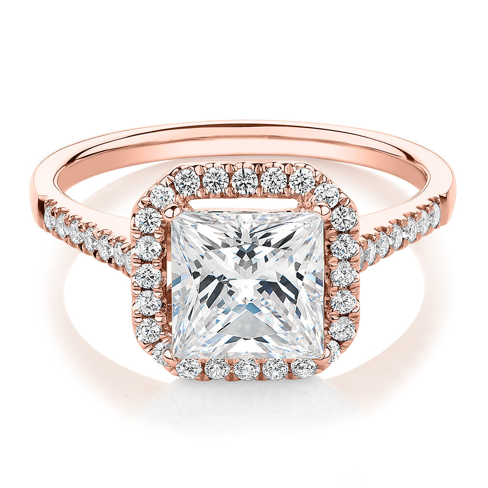Princess Cut and Round Brilliant halo engagement ring with 2.21 carats* of diamond simulants in 14 carat rose gold