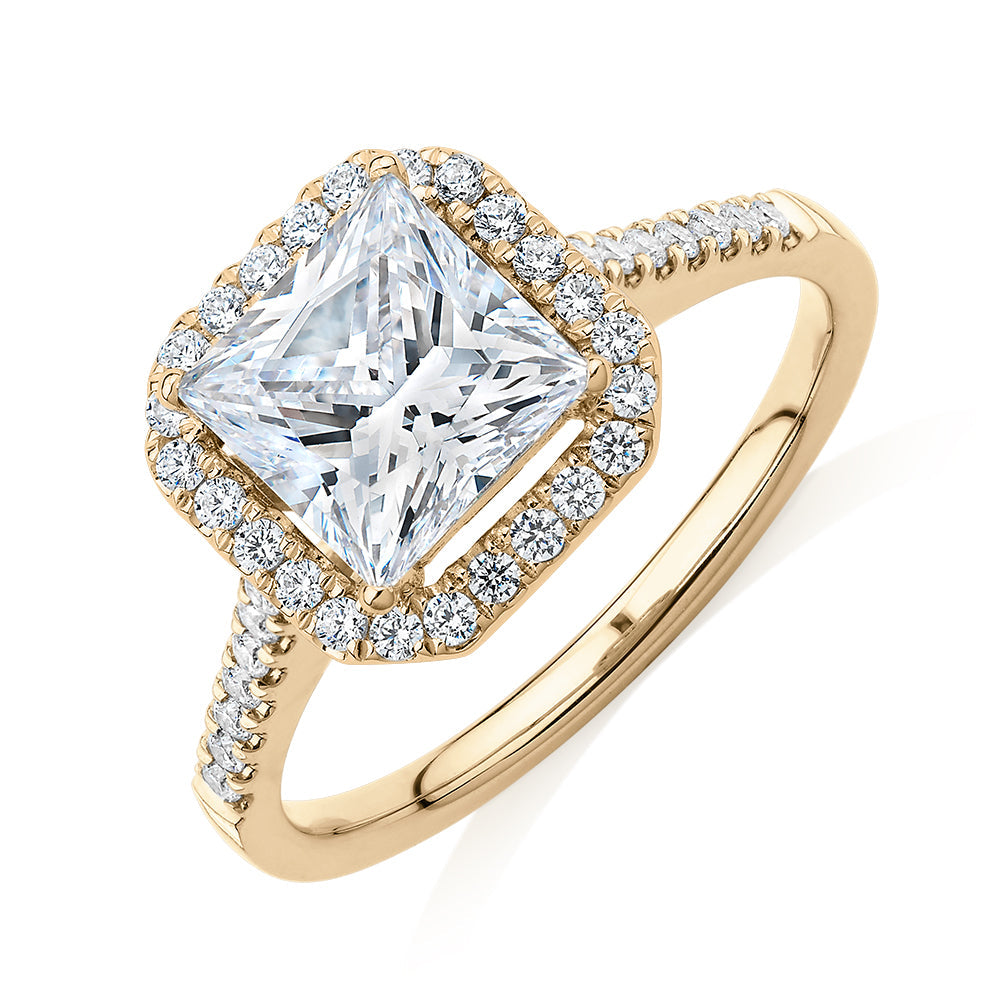 Princess Cut and Round Brilliant halo engagement ring with 2.21 carats* of diamond simulants in 14 carat yellow gold