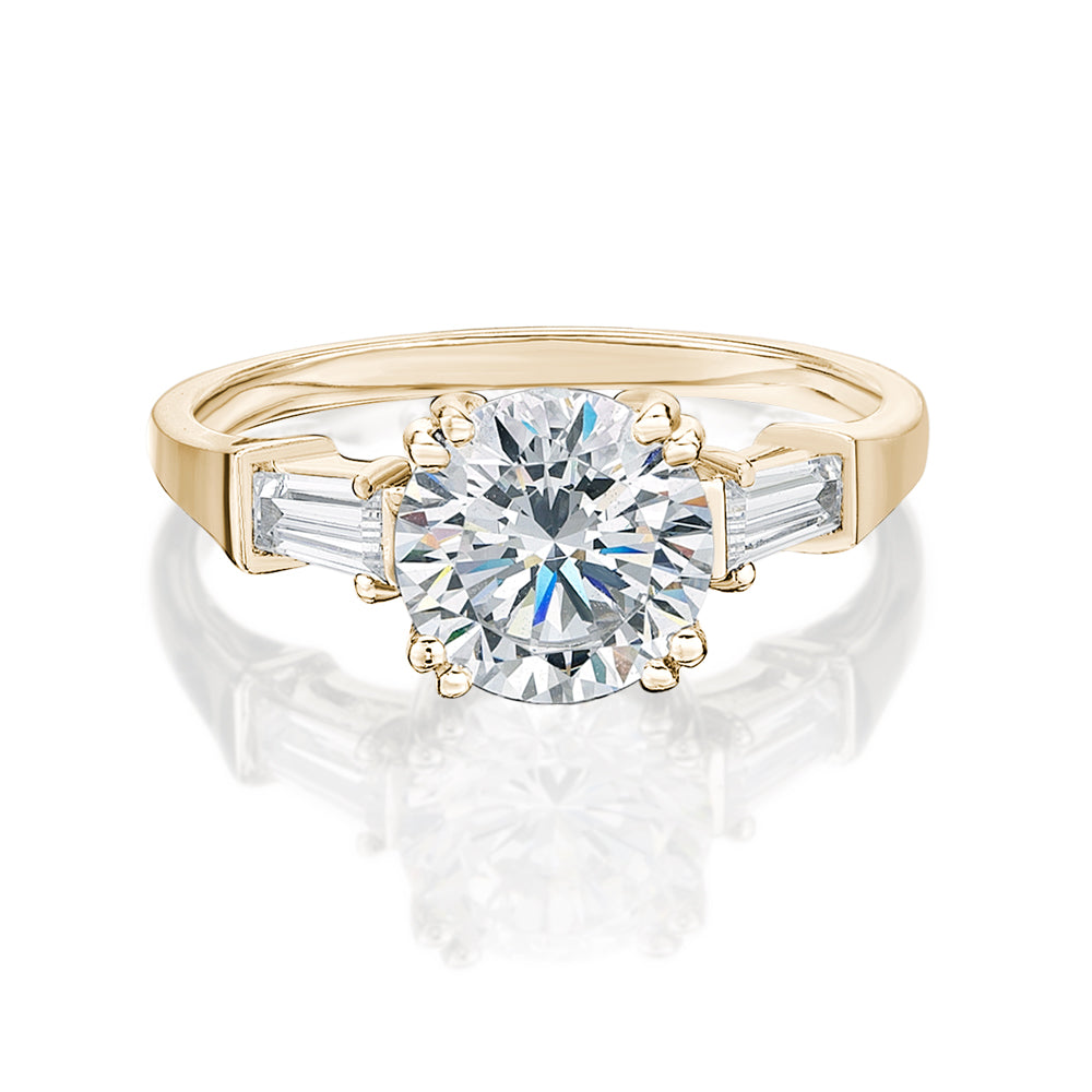 Round Brilliant and Baguette shouldered engagement ring with 2.46 carats* of diamond simulants in 10 carat yellow gold