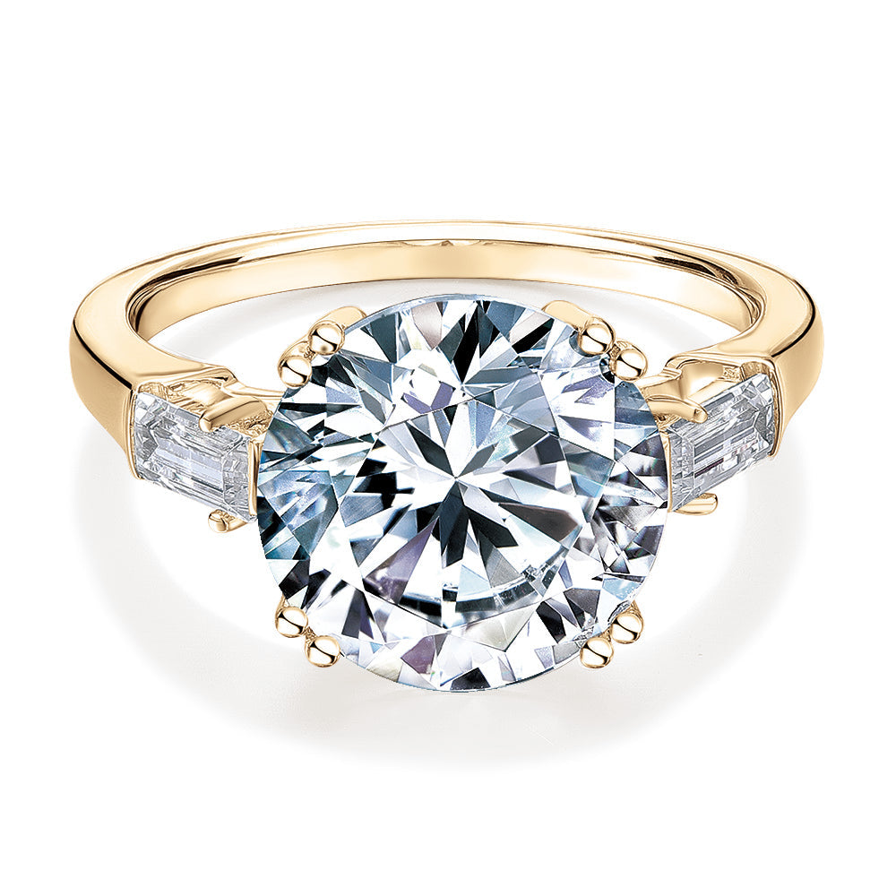 Round Brilliant and Baguette shouldered engagement ring with 5.33 carats* of diamond simulants in 10 carat yellow gold