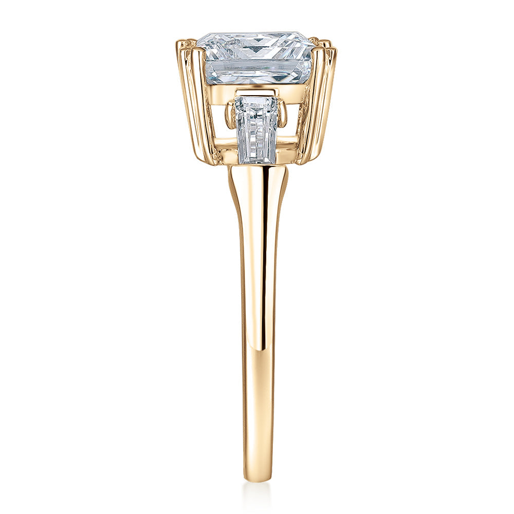Princess Cut and Baguette shouldered engagement ring with 3.43 carats* of diamond simulants in 10 carat yellow gold