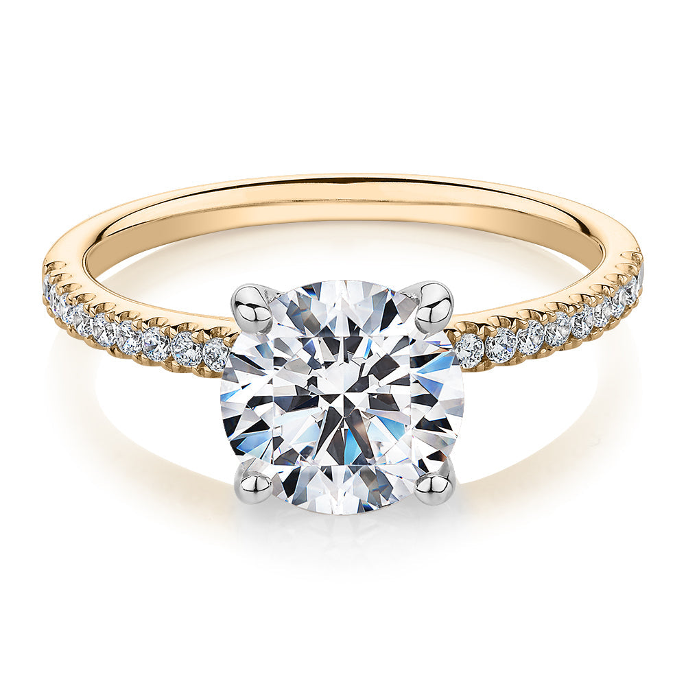 Round Brilliant shouldered engagement ring with 2.17 carats* of diamond simulants in 14 carat yellow and white gold