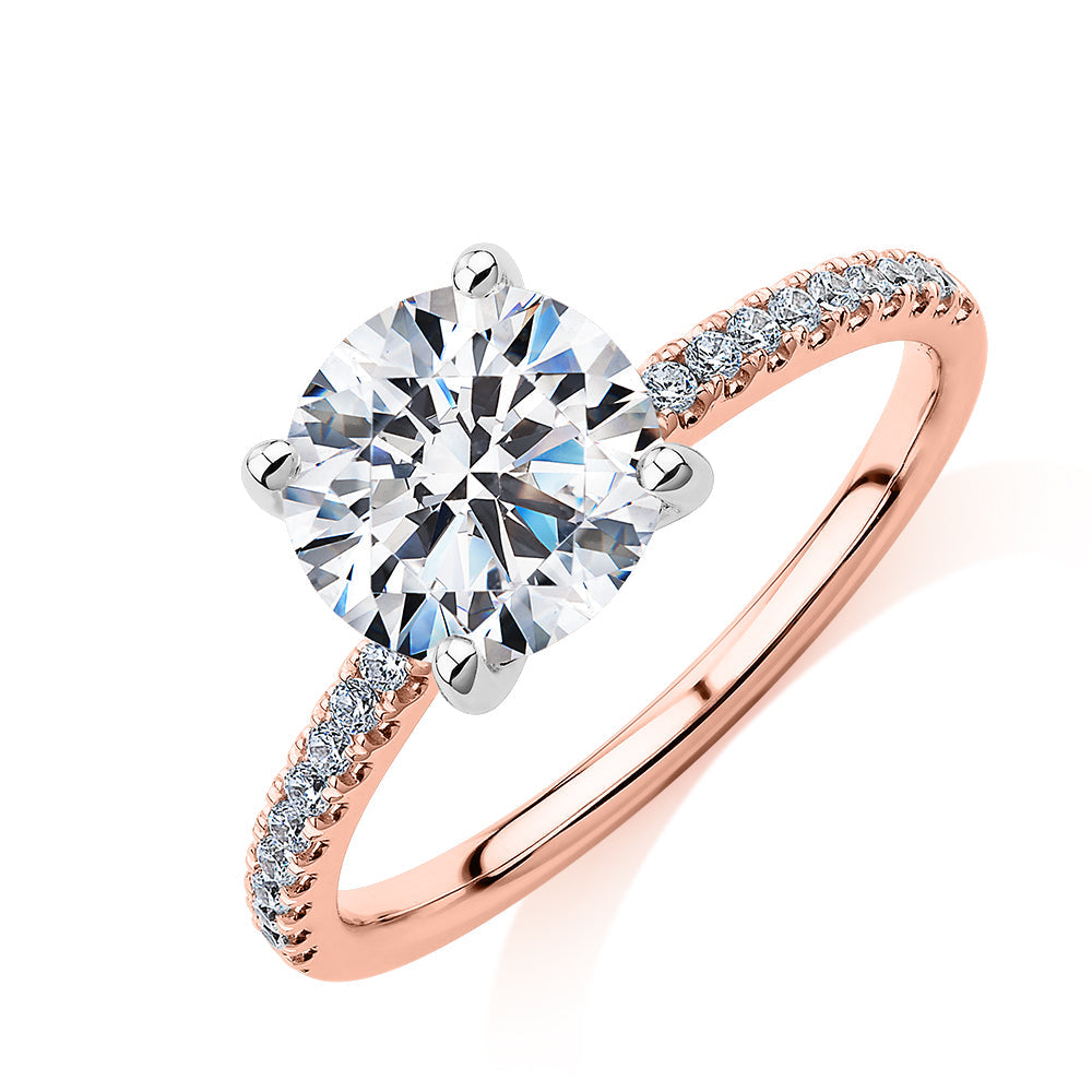 Round Brilliant shouldered engagement ring with 2.17 carats* of diamond simulants in 14 carat rose and white gold