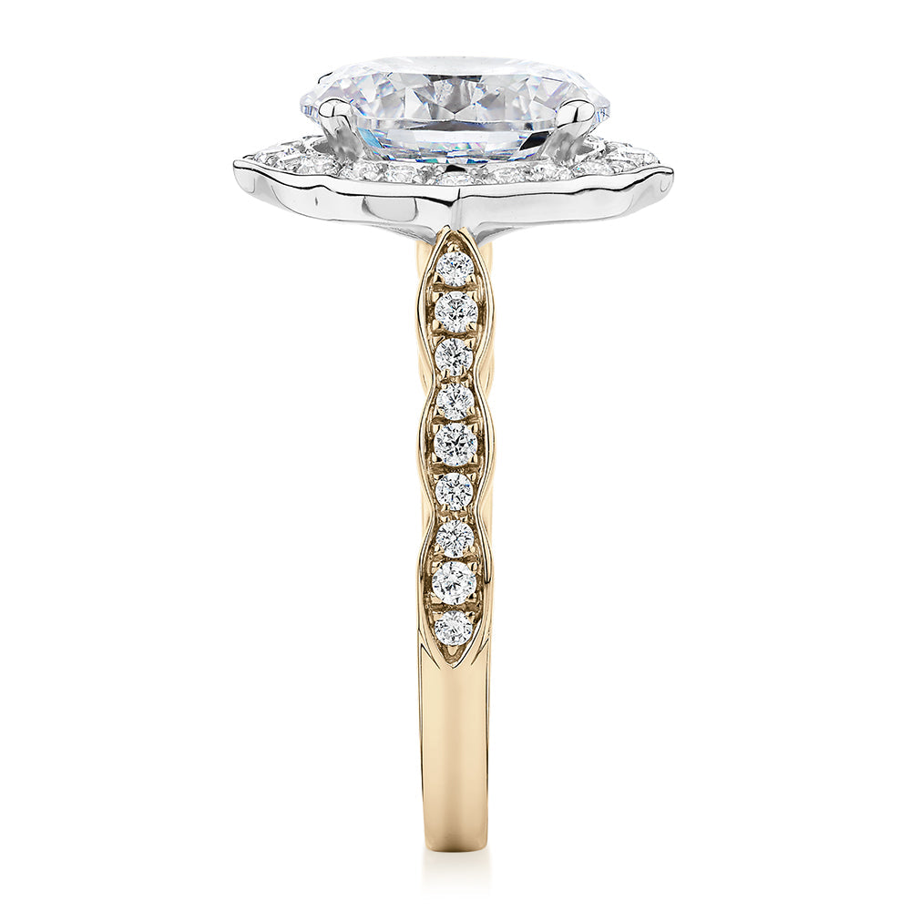 Oval and Round Brilliant halo engagement ring with 2.86 carats* of diamond simulants in 14 carat yellow and white gold