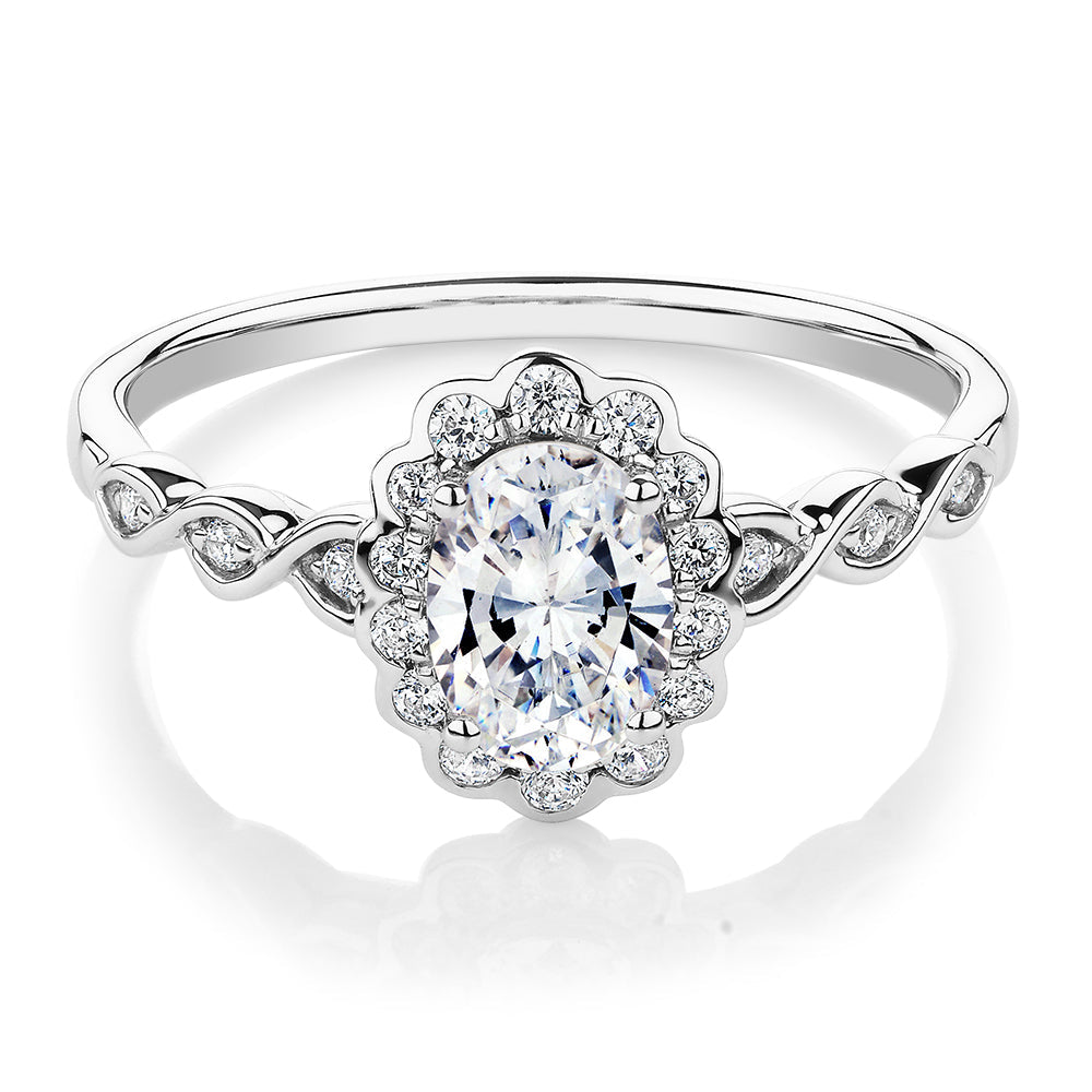 Oval and Round Brilliant halo engagement ring with 0.97 carats* of diamond simulants in 10 carat white gold