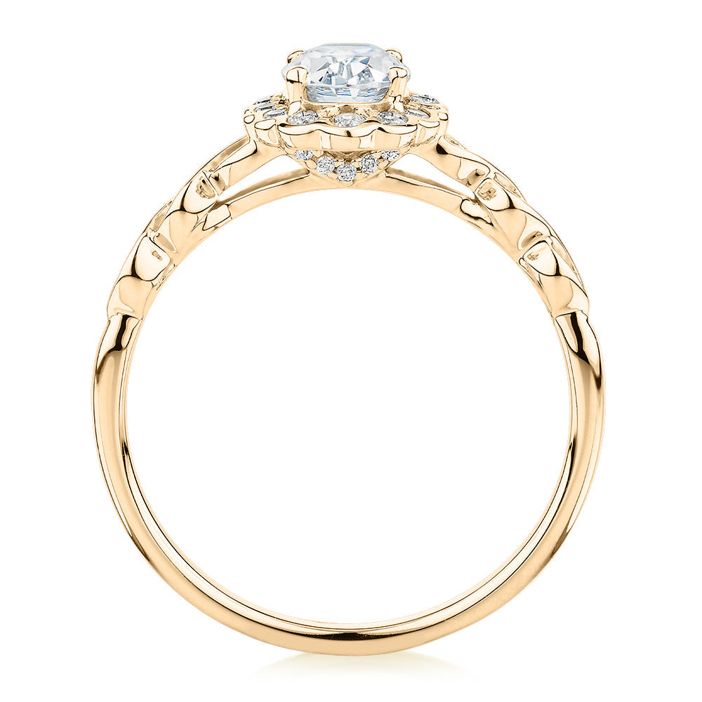 Oval and Round Brilliant halo engagement ring with 0.97 carats* of diamond simulants in 10 carat yellow gold