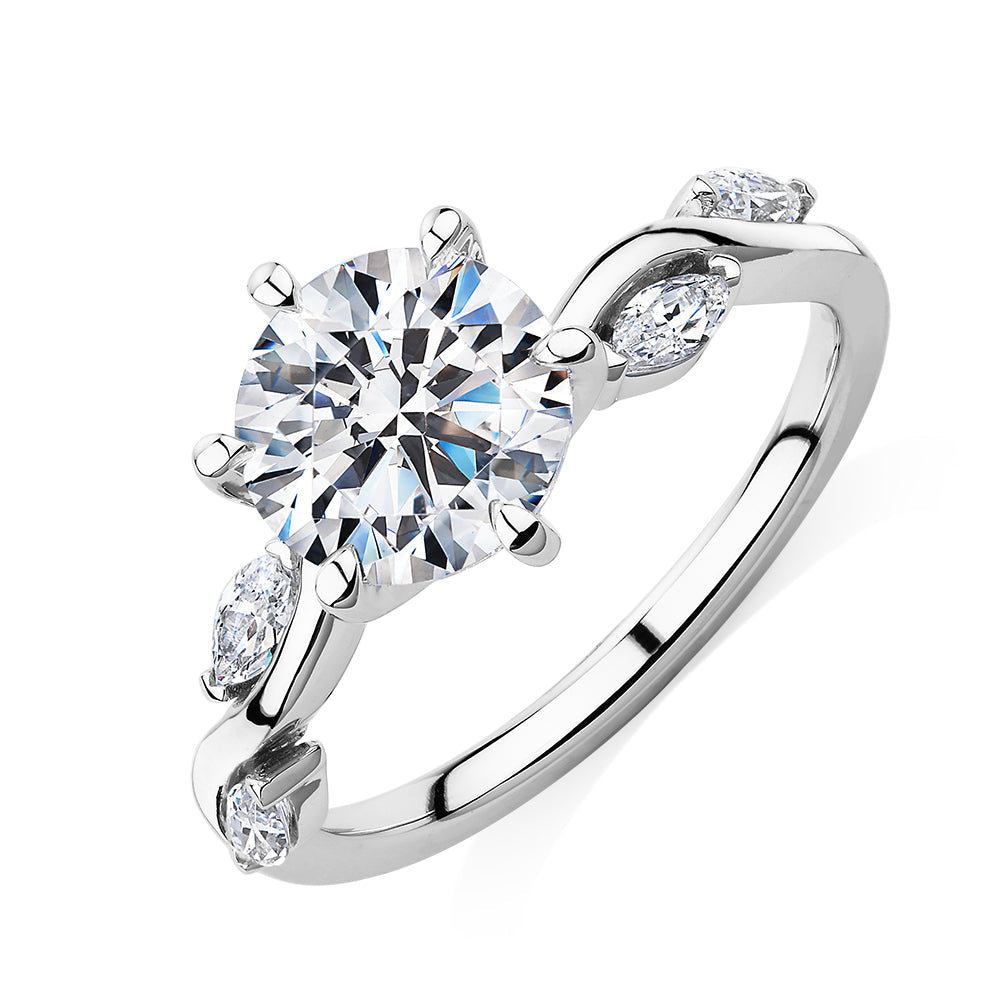 Round Brilliant and Marquise shouldered engagement ring with 2.44 carats* of diamond simulants in 14 carat white gold