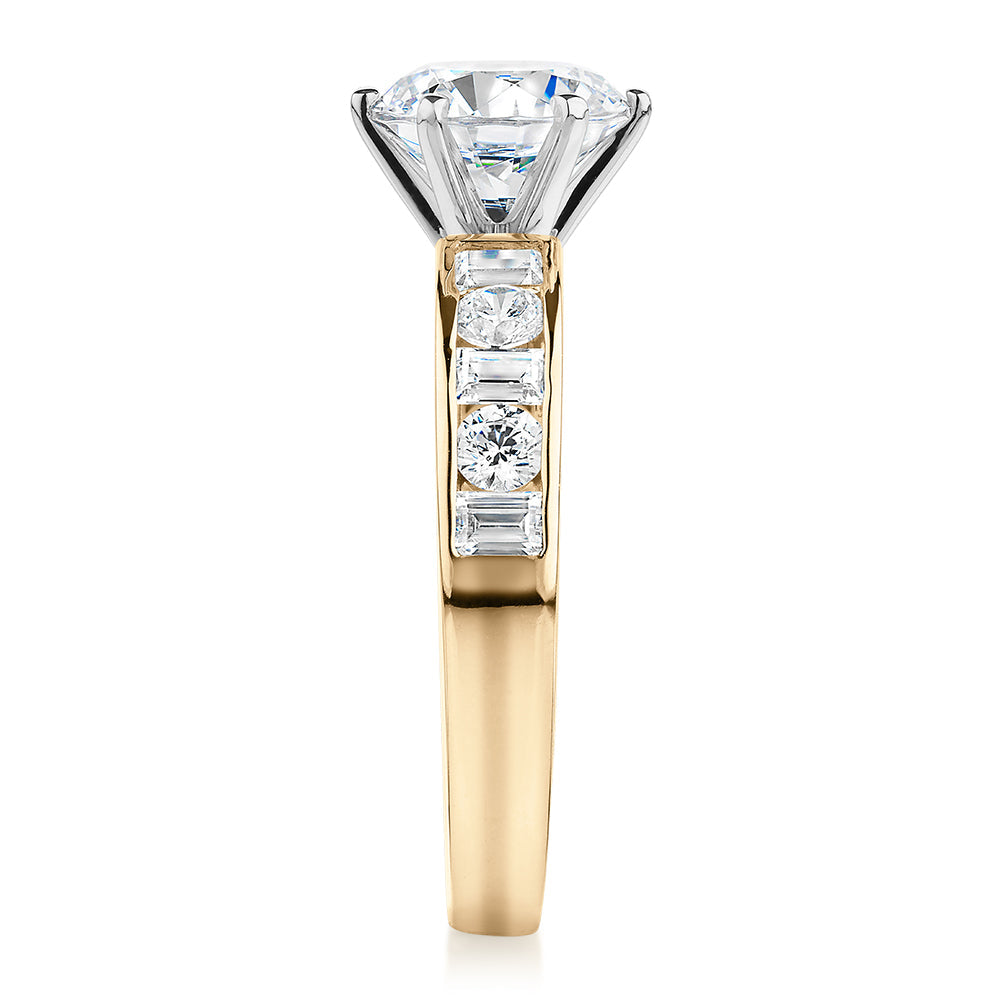 Round Brilliant and Baguette shouldered engagement ring with 2.72 carats* of diamond simulants in 14 carat yellow and white gold