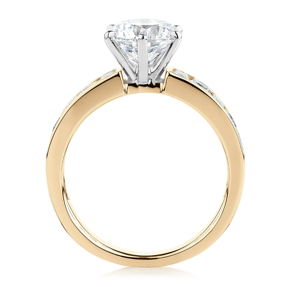 Round Brilliant and Baguette shouldered engagement ring with 2.72 carats* of diamond simulants in 14 carat yellow and white gold