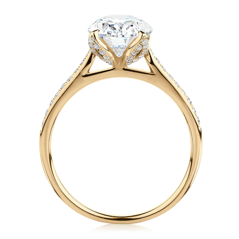 Oval and Round Brilliant shouldered engagement ring with 2.83 carats* of diamond simulants in 14 carat yellow gold