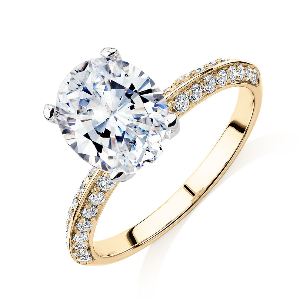 Oval shouldered engagement ring with 2.97 carats* of diamond simulants in 14 carat yellow and white gold