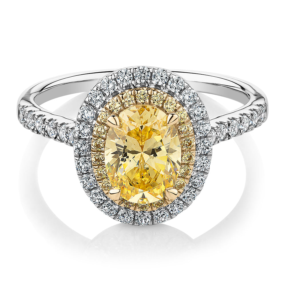 Oval and Round Brilliant halo engagement ring with 1.68 carats* of diamond simulants in 10 carat white and yellow gold