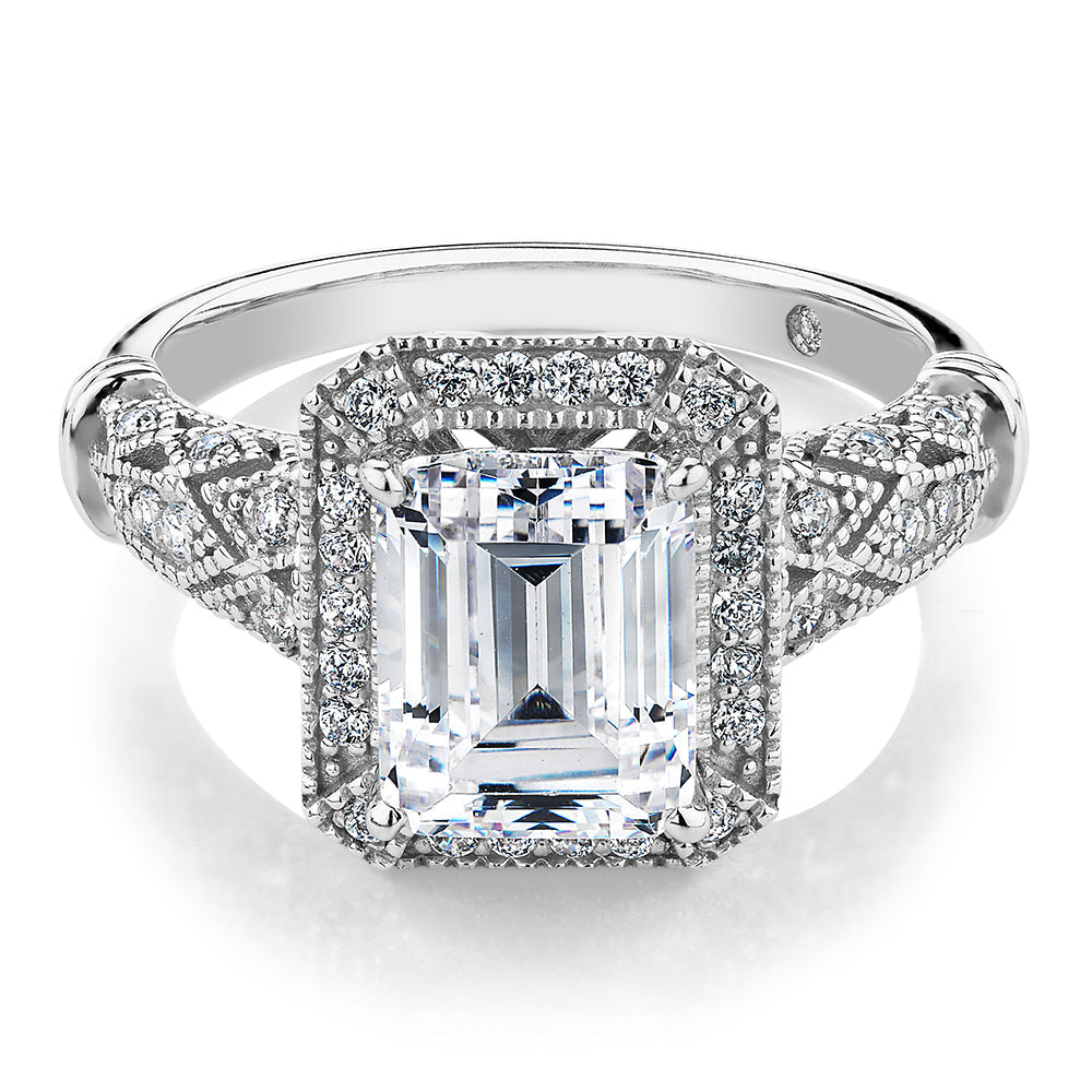 Emerald Cut and Round Brilliant halo engagement ring with 2.9 carats* of diamond simulants in 10 carat white gold