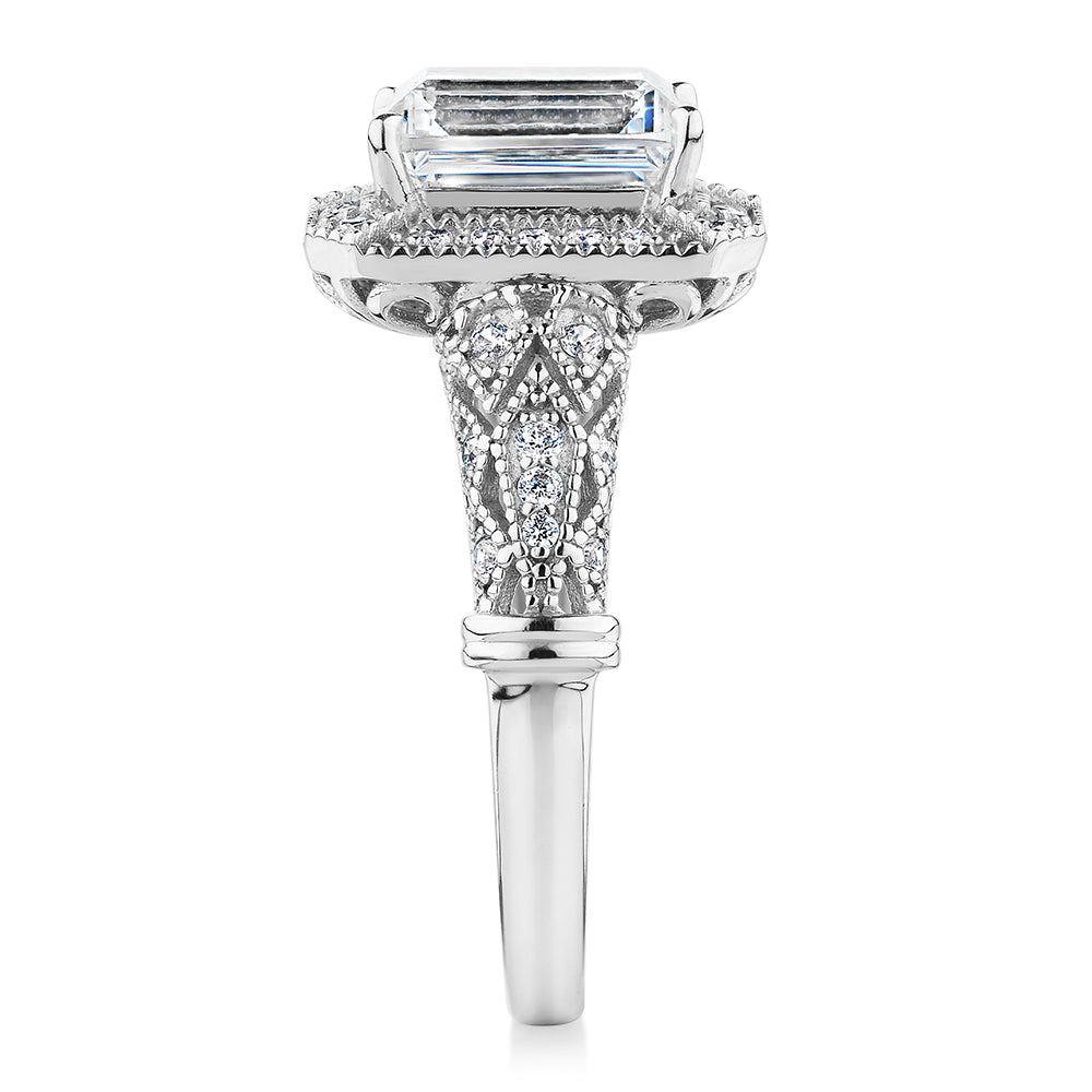 Emerald Cut and Round Brilliant halo engagement ring with 2.9 carats* of diamond simulants in 10 carat white gold
