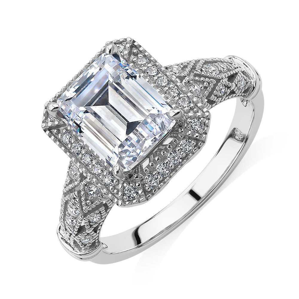 Emerald Cut and Round Brilliant halo engagement ring with 2.9 carats* of diamond simulants in 10 carat white gold