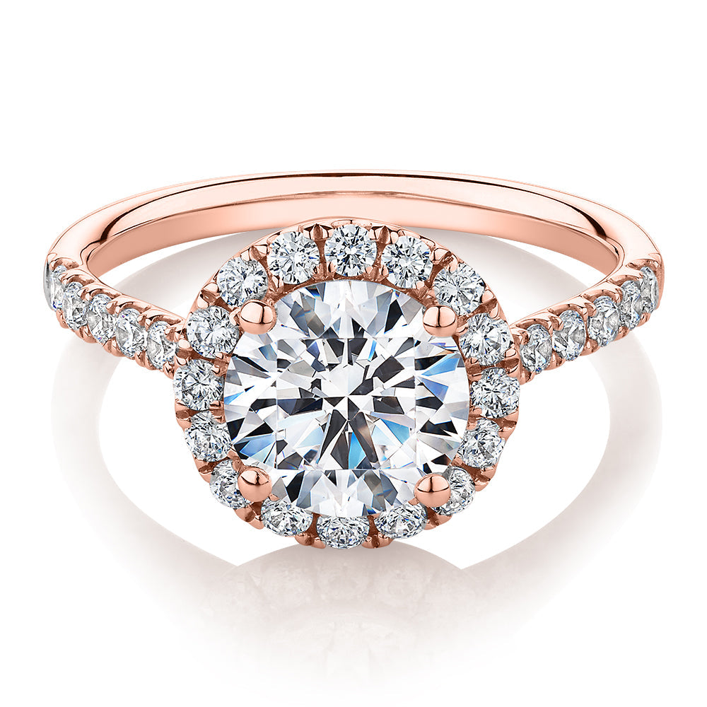 Round Brilliant halo engagement ring with 2.46 carats* of diamond simulants in 10 carat rose gold