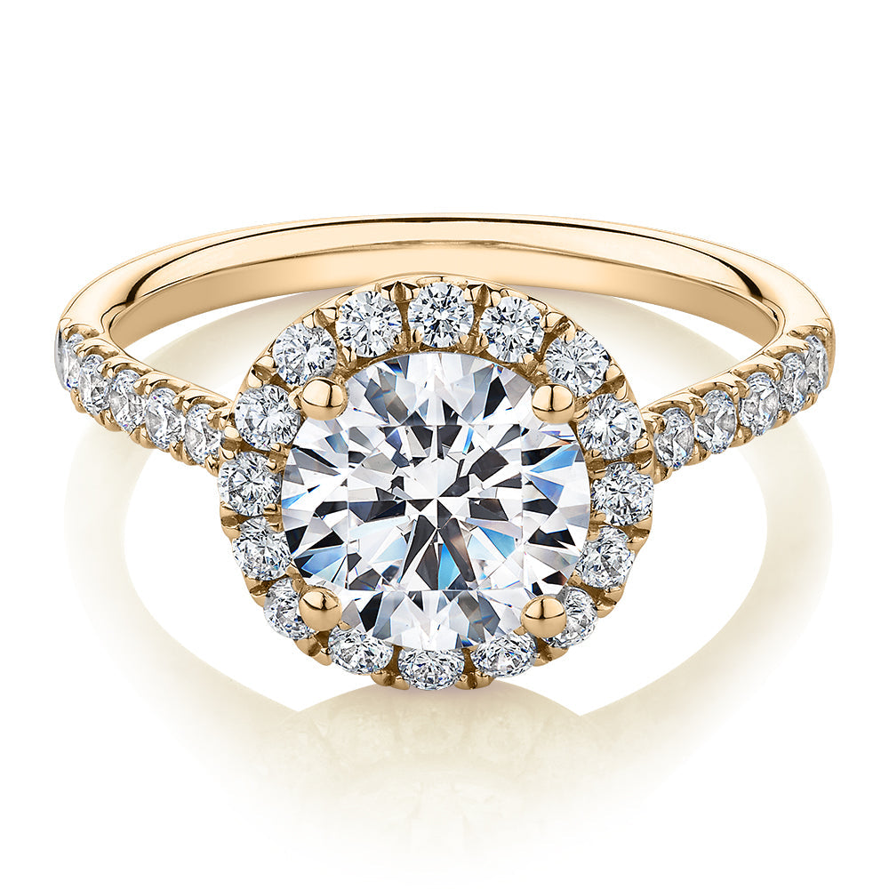 Round Brilliant halo engagement ring with 2.46 carats* of diamond simulants in 10 carat yellow gold