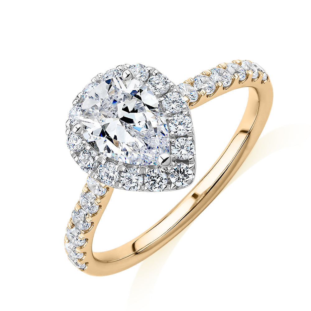Pear and Round Brilliant halo engagement ring with 1.83 carats* of diamond simulants in 14 carat yellow and white gold