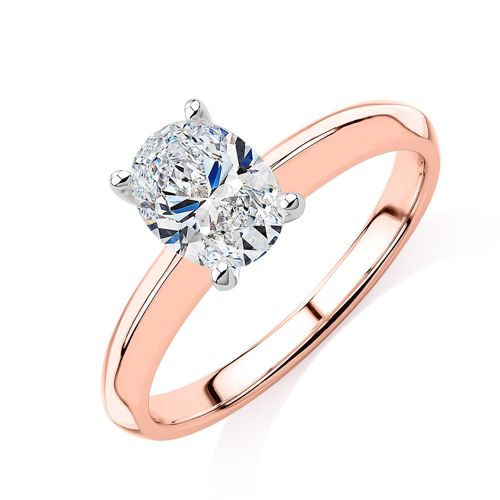 Oval solitaire engagement ring with 1.21 carat* diamond simulant in 14 carat rose and white gold