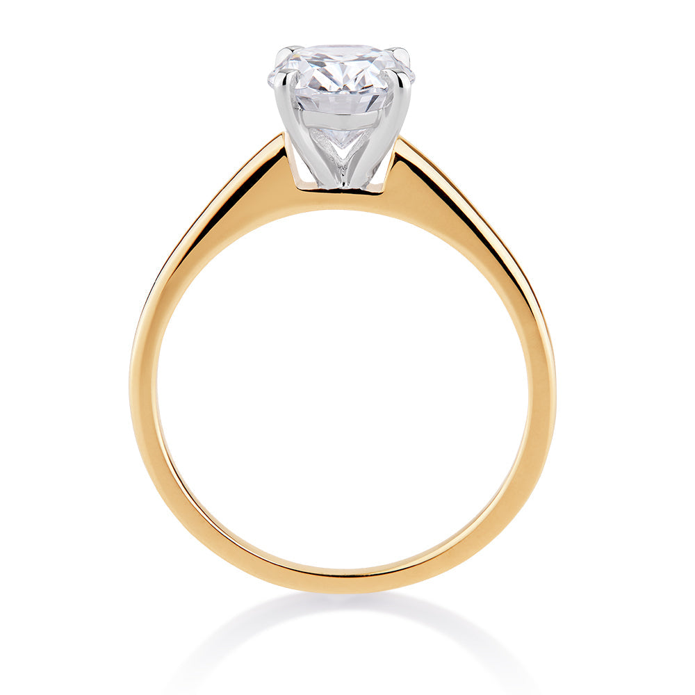 Oval solitaire engagement ring with 2 carat* diamond simulant in 14 carat yellow and white gold