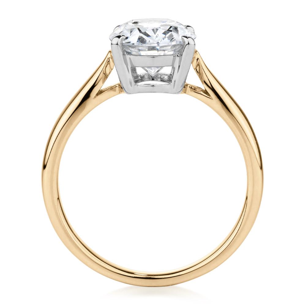 Oval solitaire engagement ring with 2.54 carat* diamond simulant in 10 carat yellow and white gold