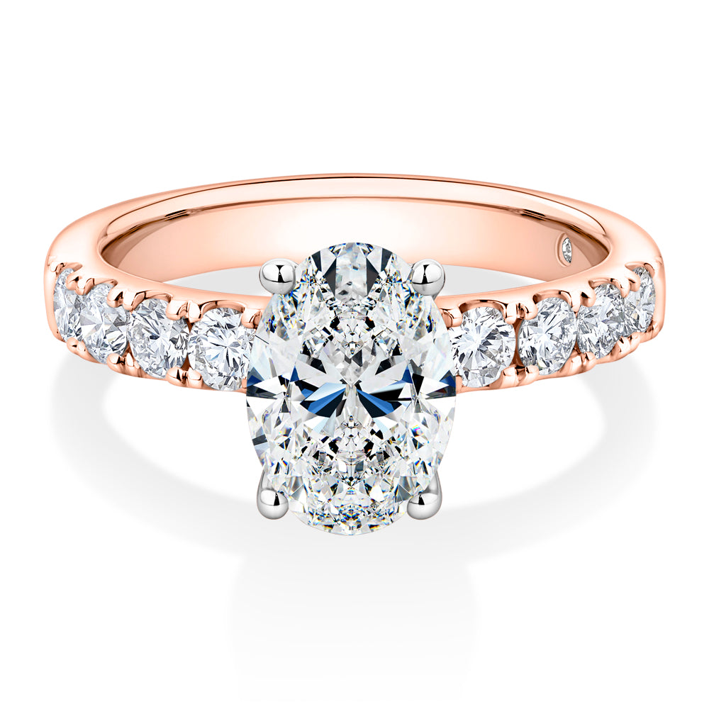Lab-Grown Simulant, 2.62 carat*TW oval and round brilliant shouldered solitaire engagement ring in 10 carat rose and white gold