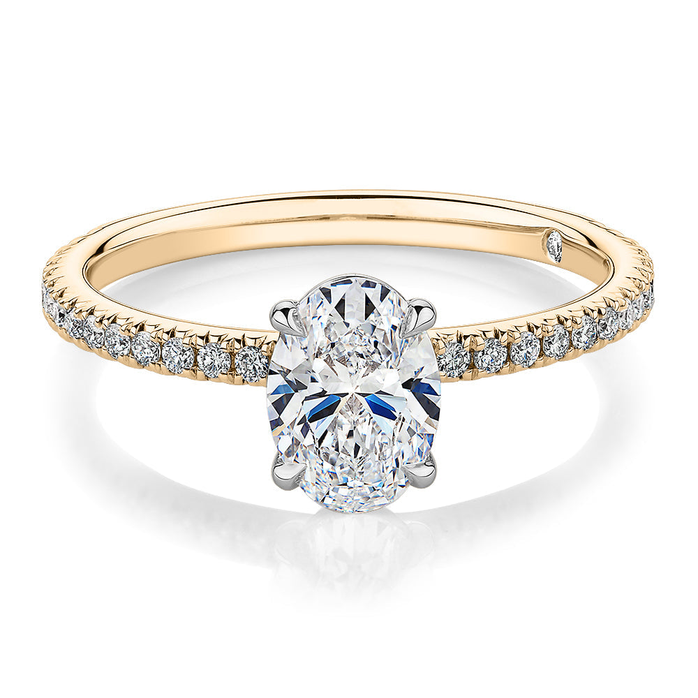 Signature Simulant Diamond 1.19 carat* TW oval cut shouldered engagement ring in 10 carat yellow and white gold