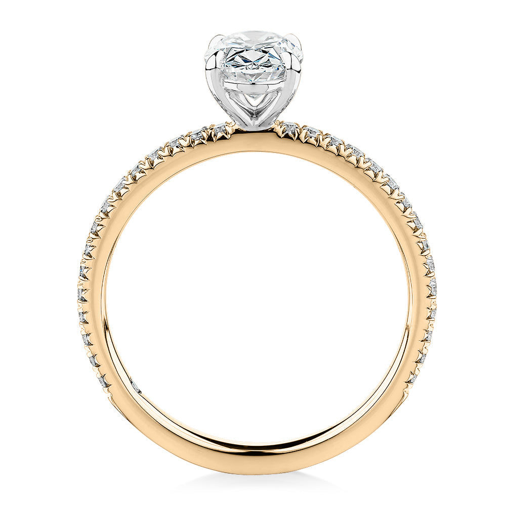 Signature Simulant Diamond 1.19 carat* TW oval cut shouldered engagement ring in 10 carat yellow and white gold