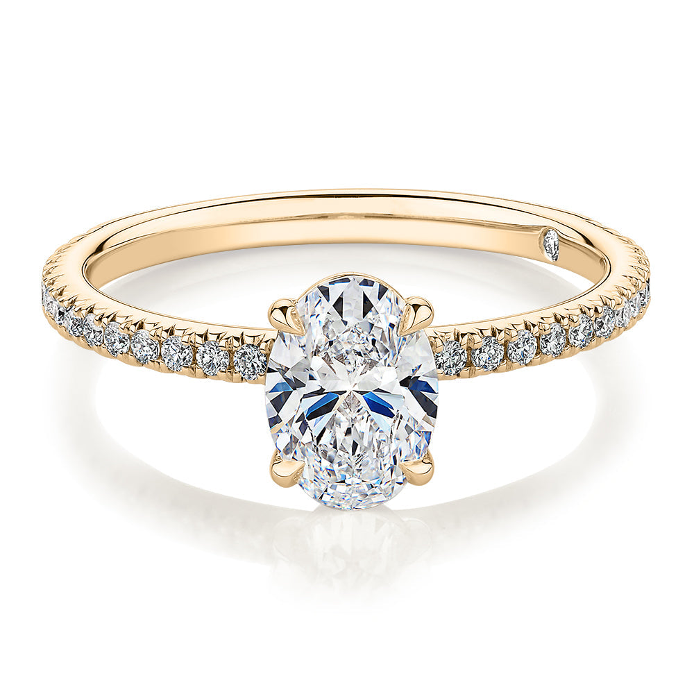 Signature Simulant Diamond 1.19 carat* TW round oval cut engagement ring in 10 carat yellow gold