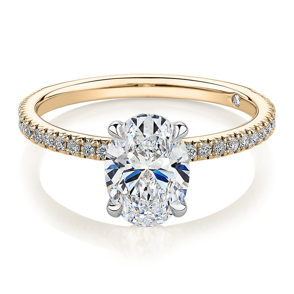 Signature Simulant Diamond 1.79 carat* TW oval cut shouldered engagement ring in 10 carat yellow and white gold